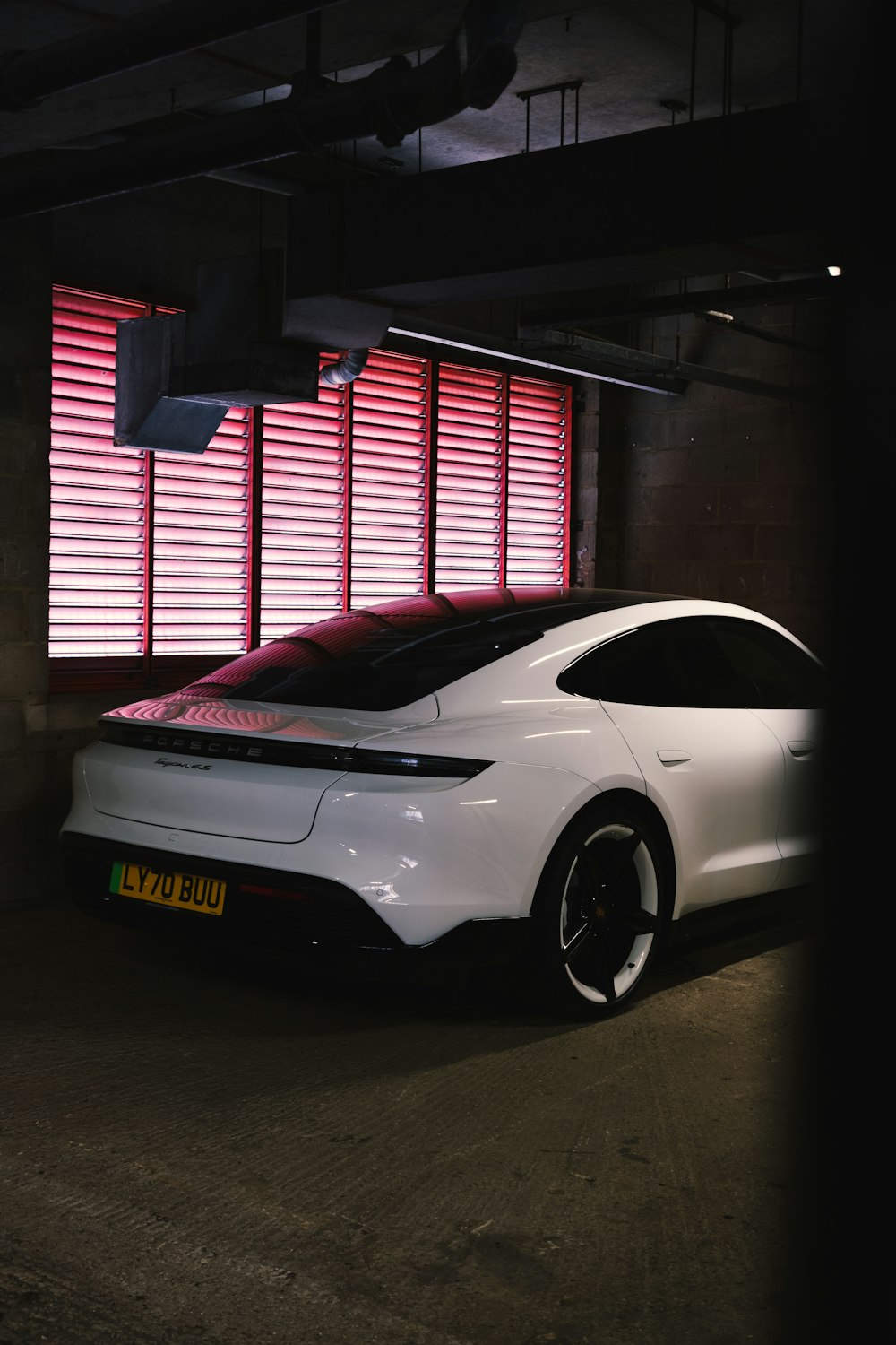 a white car parked in a parking garage