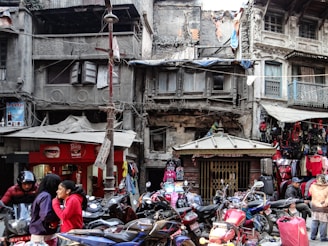 A vibrant street scene in Yogyakarta with motorcycles parked in front of traditional Javanese buildings.
