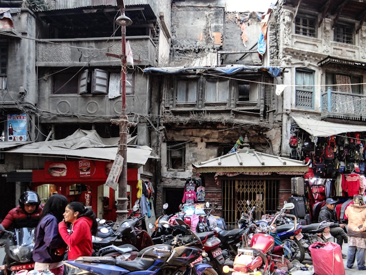 A vibrant street scene in Yogyakarta with motorcycles parked in front of traditional Javanese buildings.