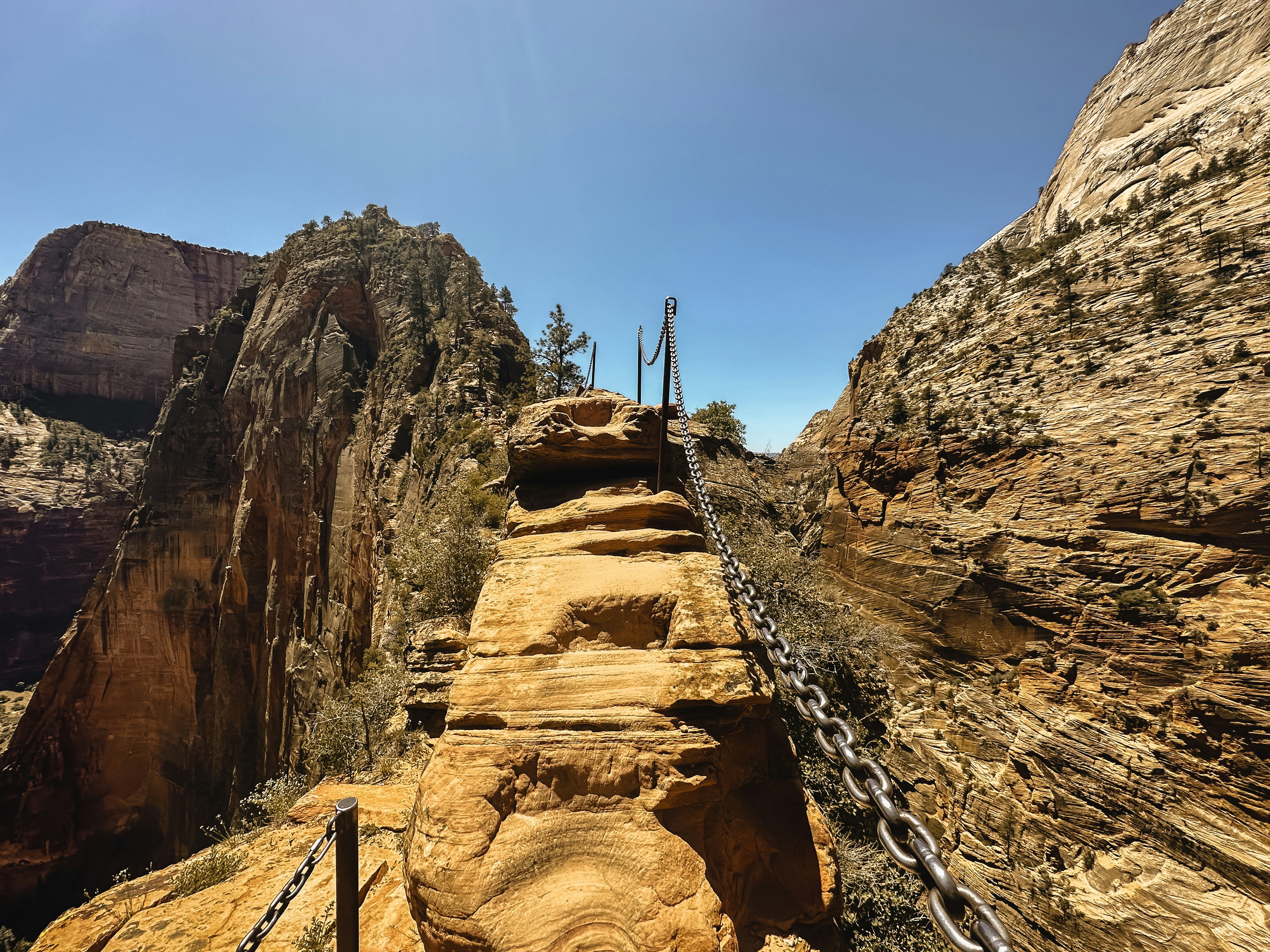 a man walking up a steep incline in the mountains