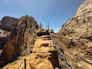 a man walking up a steep incline in the mountains
