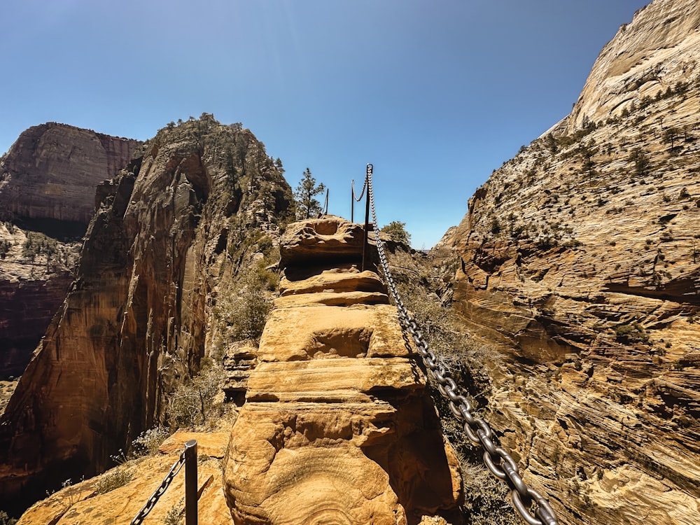 a man walking up a steep incline in the mountains