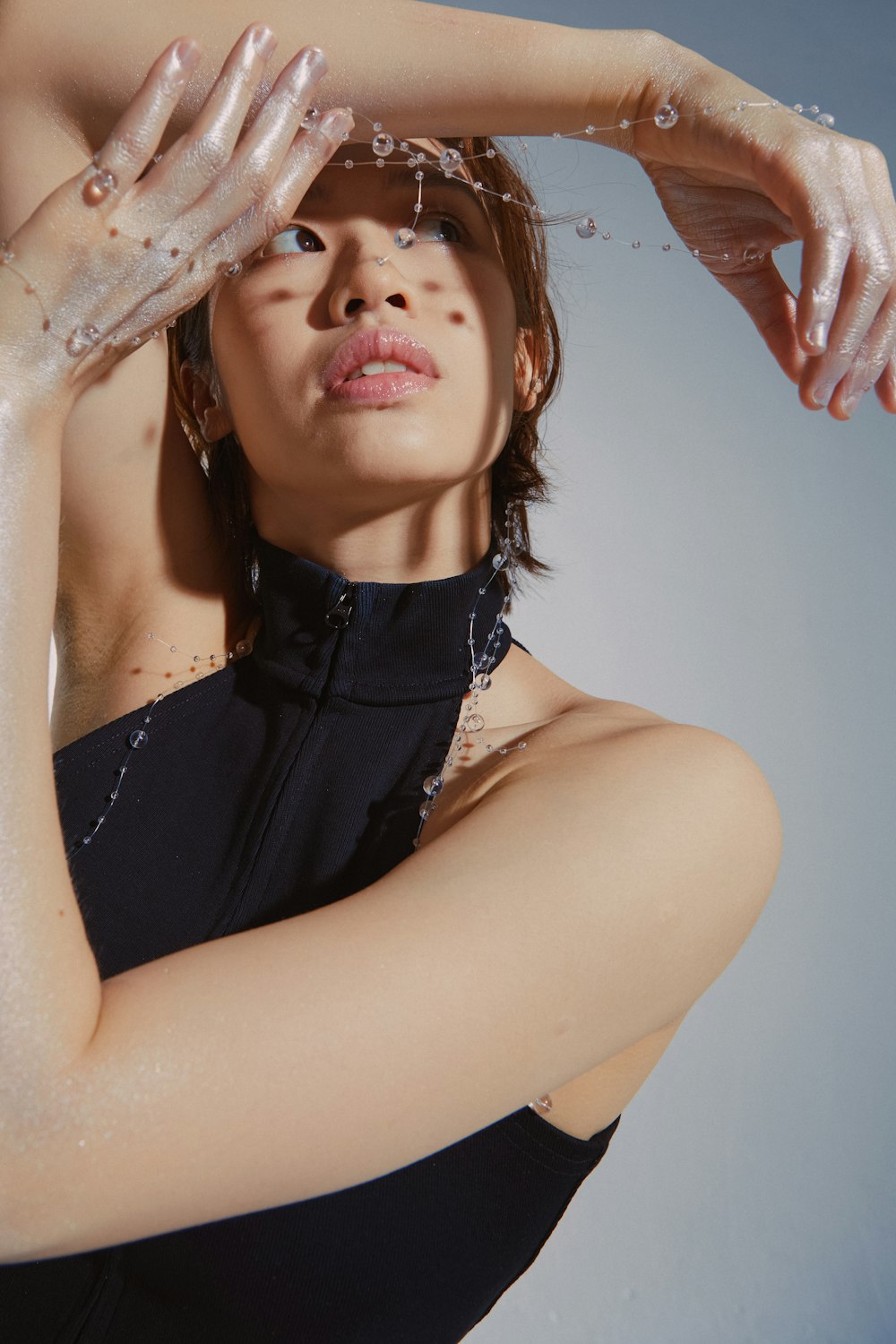 a woman in a black dress is washing her hair