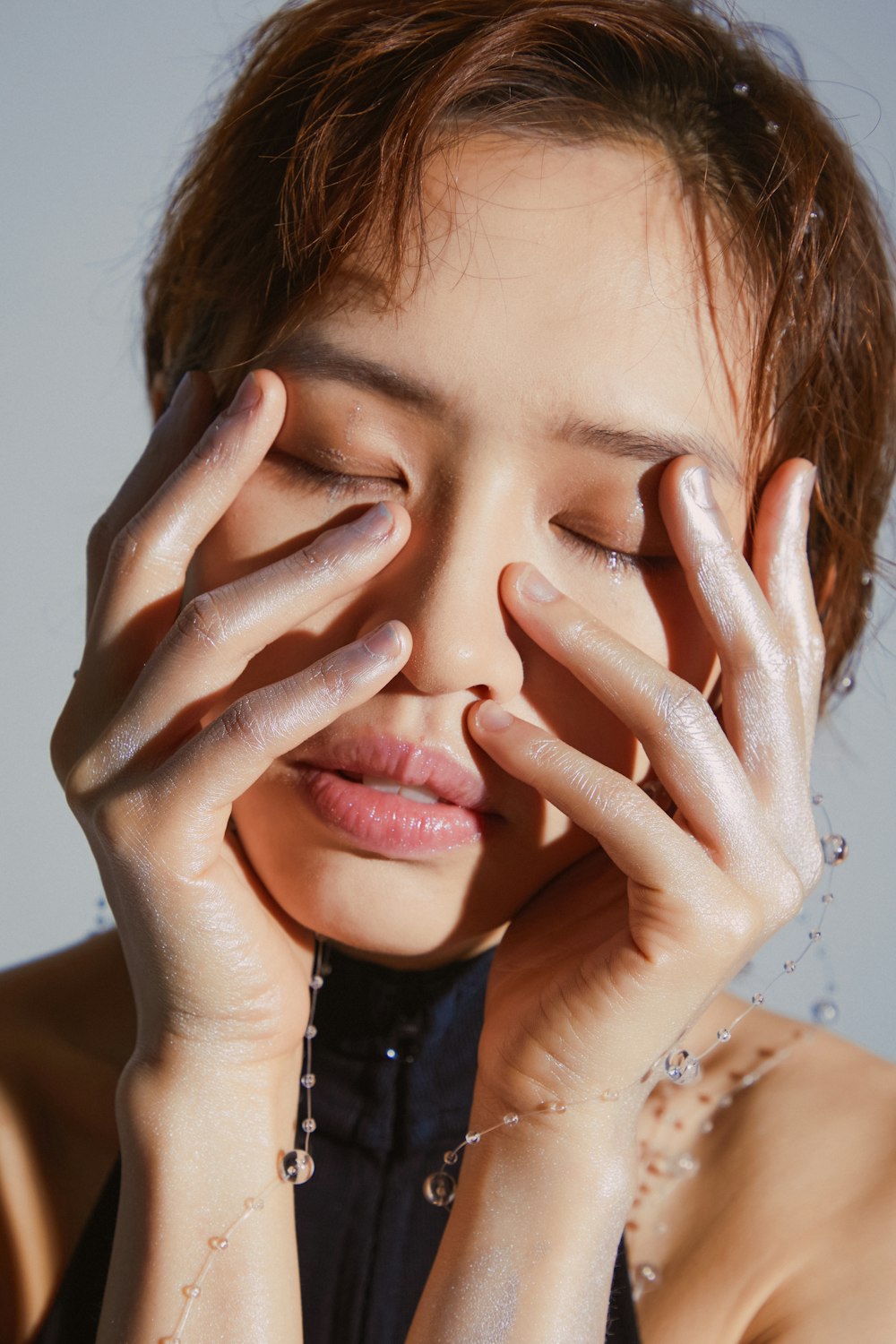 a woman with her hands on her face