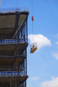 A high-speed temporary construction lift in action at a building site.