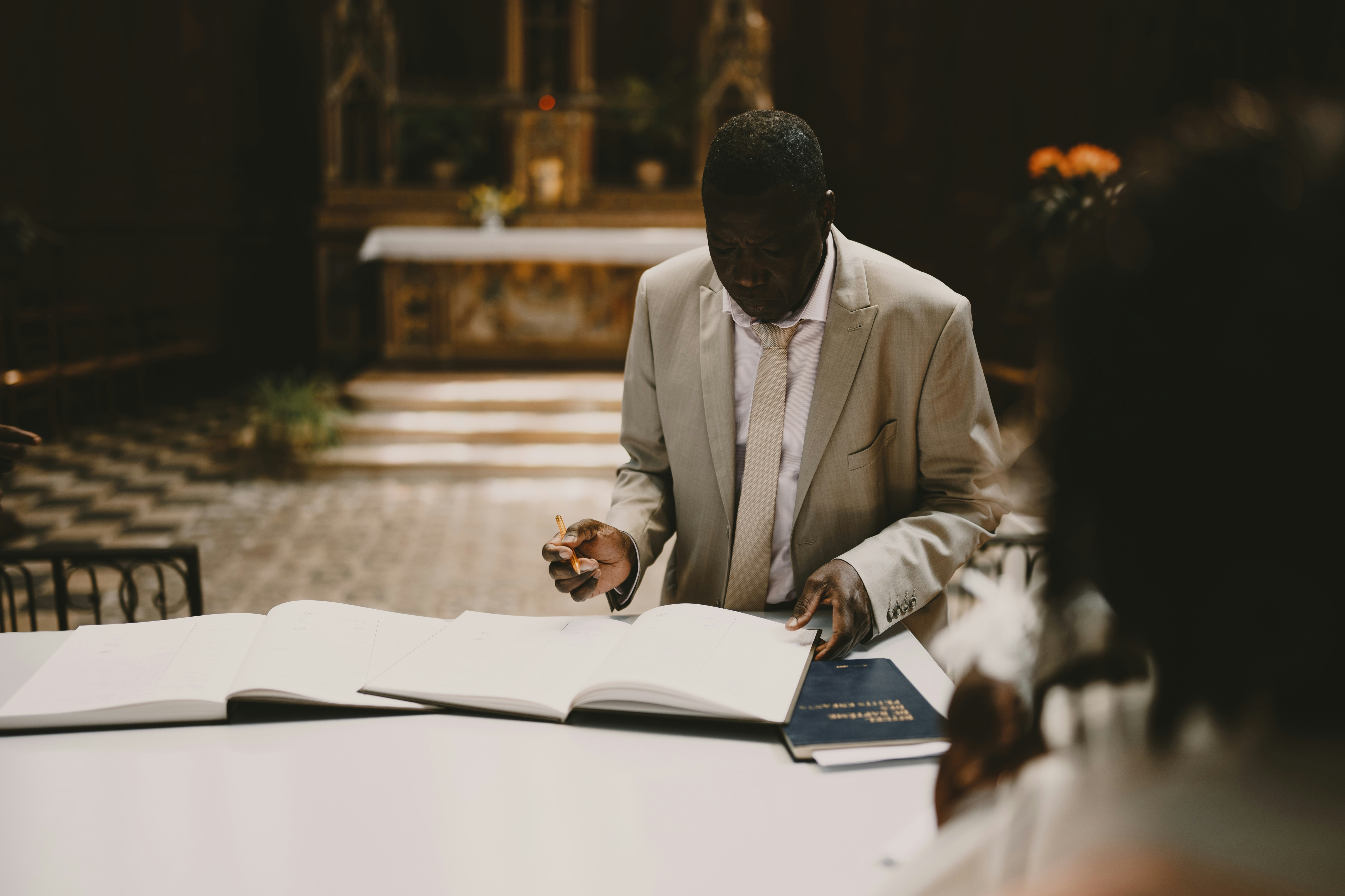 Pastor writing in book