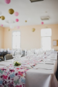 a table set with wine glasses and place settings