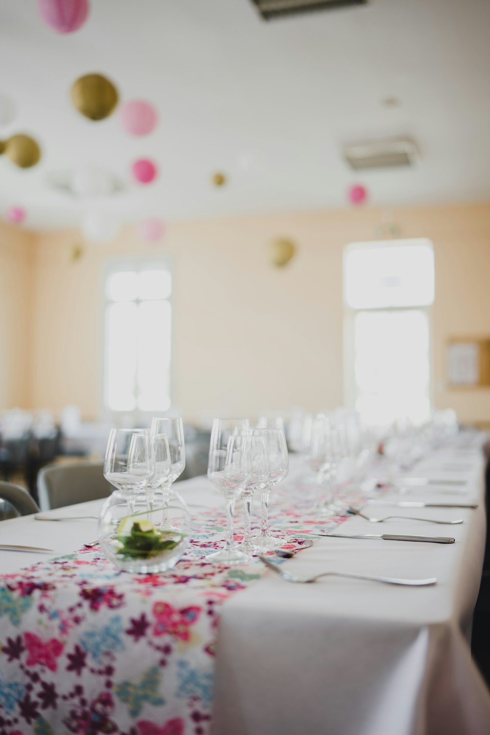 a table set with wine glasses and place settings