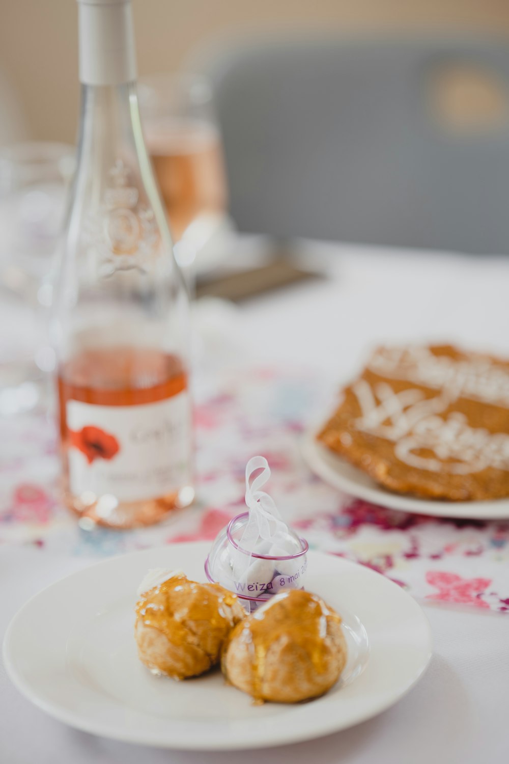 a plate of food and a bottle of wine on a table