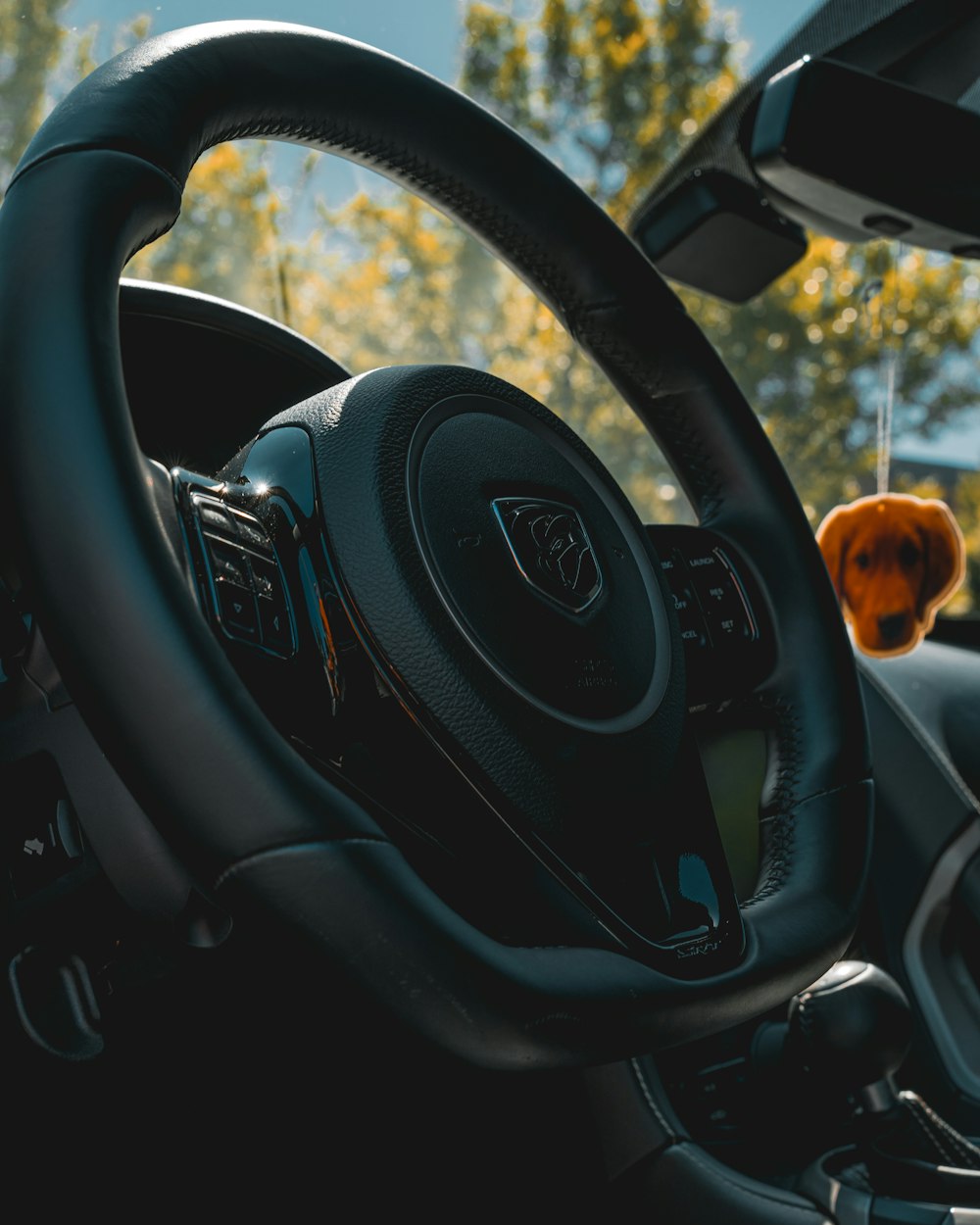 a steering wheel of a car with a dashboard