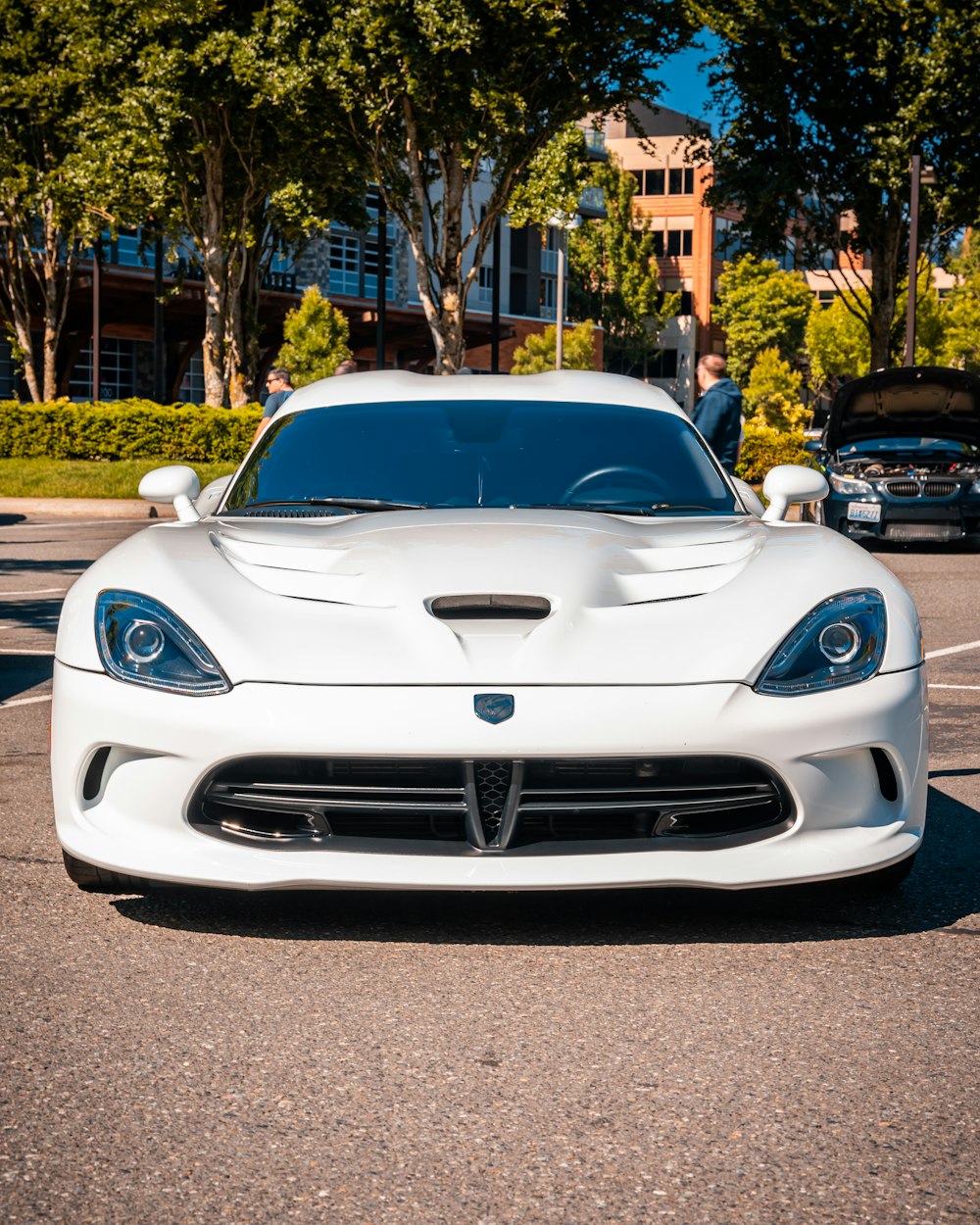 a white sports car parked in a parking lot