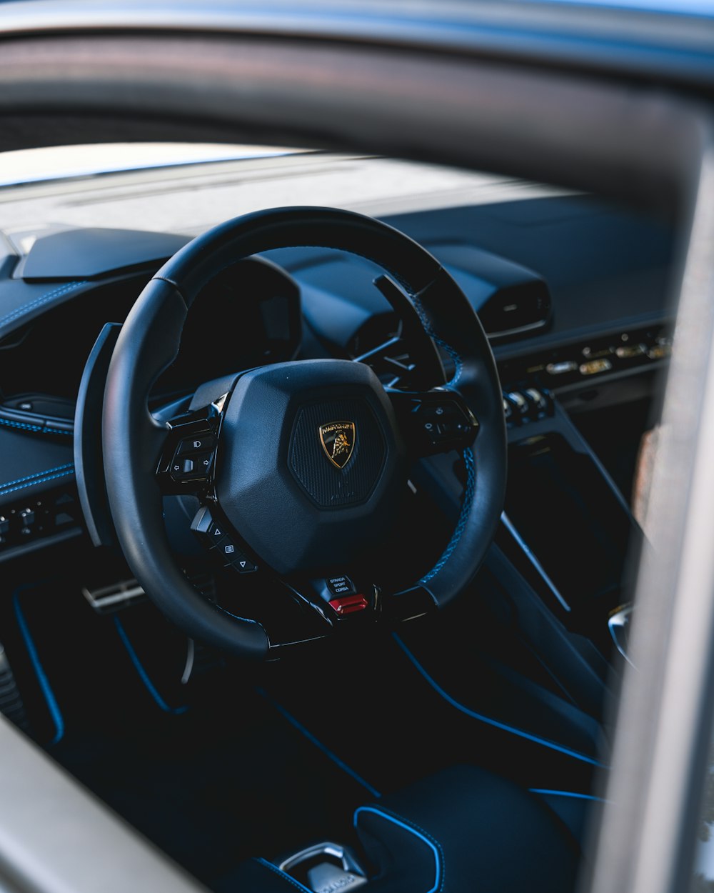 the interior of a car with a steering wheel and dashboard