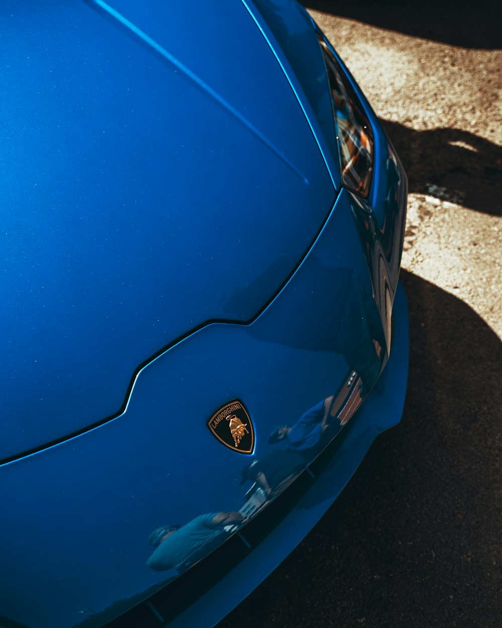 a blue sports car parked in a parking lot