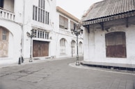 A quiet street corner with vintage signs, captured in moody black and white tones.