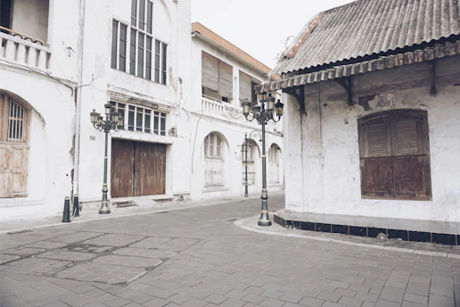 A quiet urban corner with peeling paint and scattered leaves, capturing the essence of forgotten city spaces.