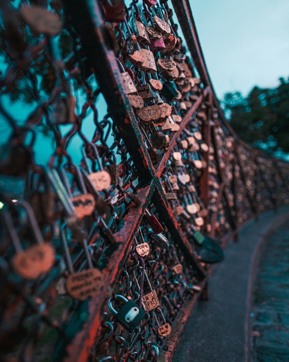 a bunch of locks attached to a fence