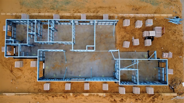 Architect reviewing blueprints with construction site in the background