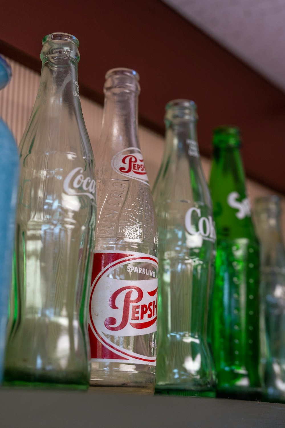 a row of soda bottles lined up on a shelf
