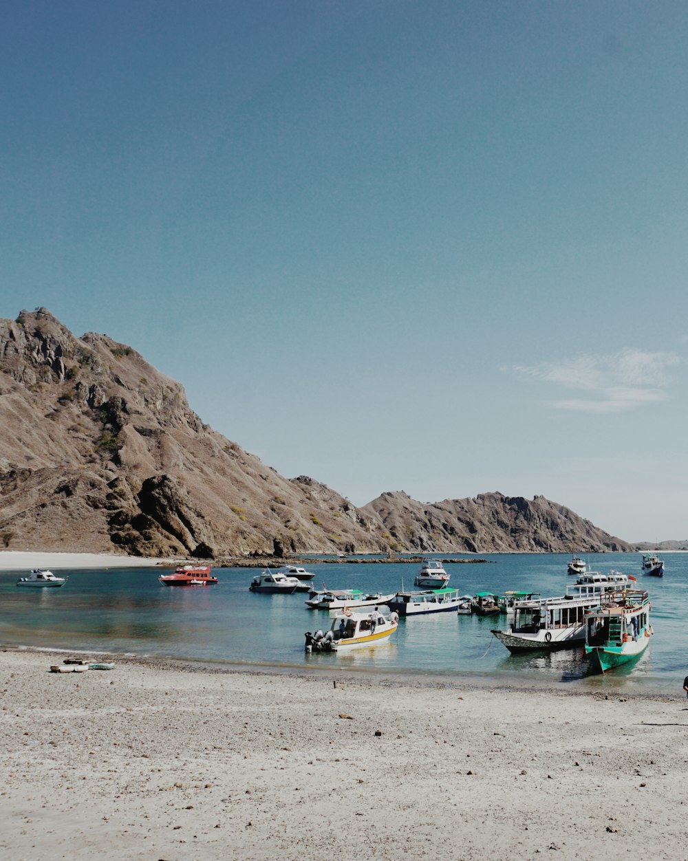 a group of boats floating on top of a body of water