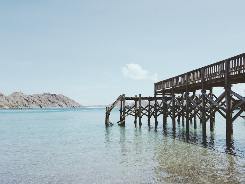 a wooden pier sitting on top of a body of water