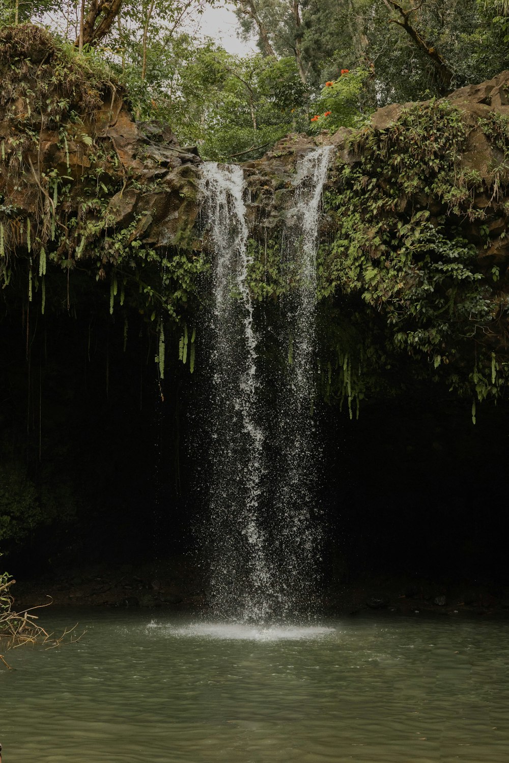 a large waterfall is coming out of the water