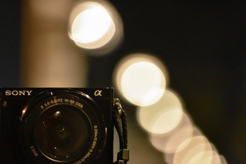 a close up of a camera with blurry lights in the background