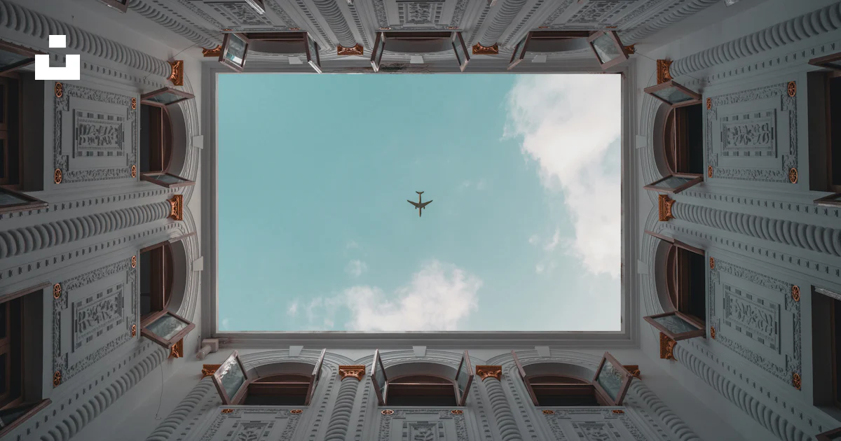 An airplane flying in the sky through a window photo – Free China Image ...