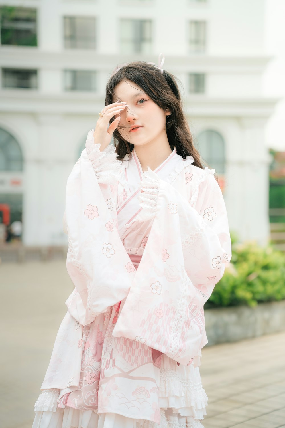 a woman in a pink kimono poses for a picture