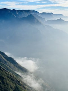 a view of a mountain range covered in fog