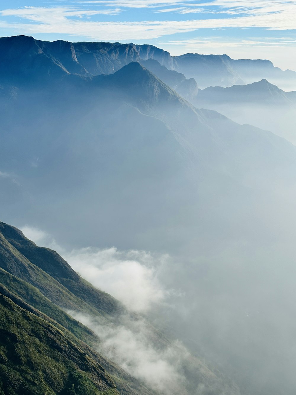 a view of a mountain range covered in fog