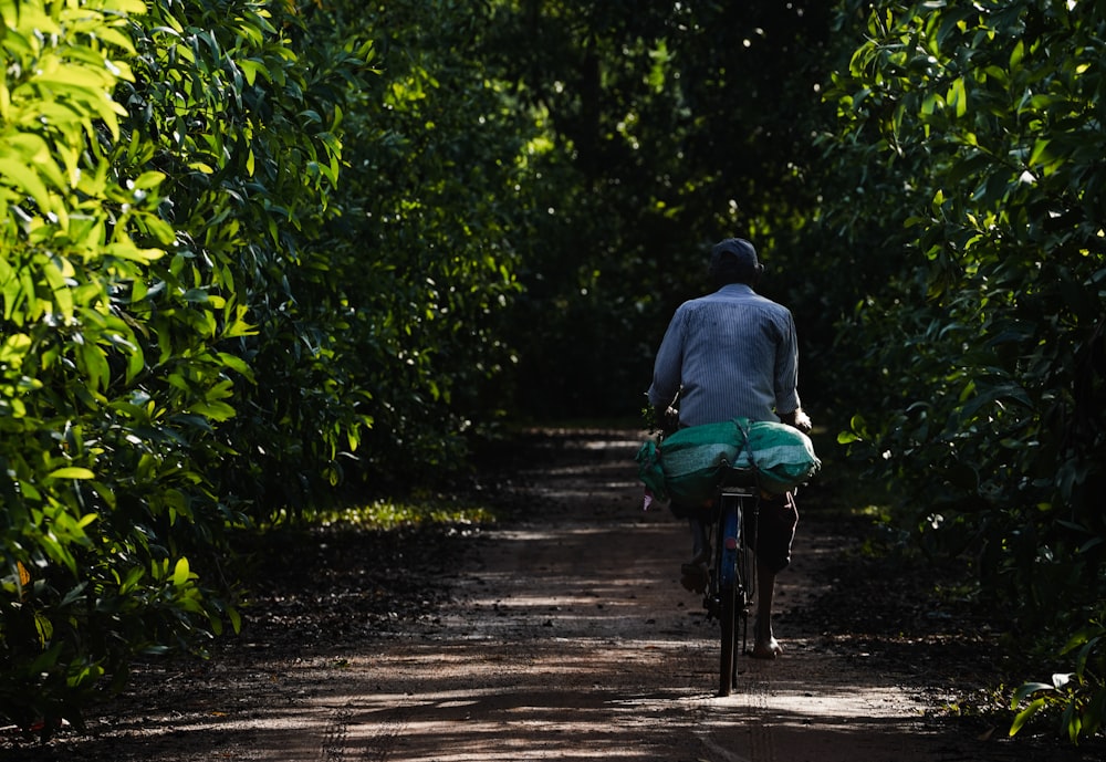 a person riding a bike down a dirt road