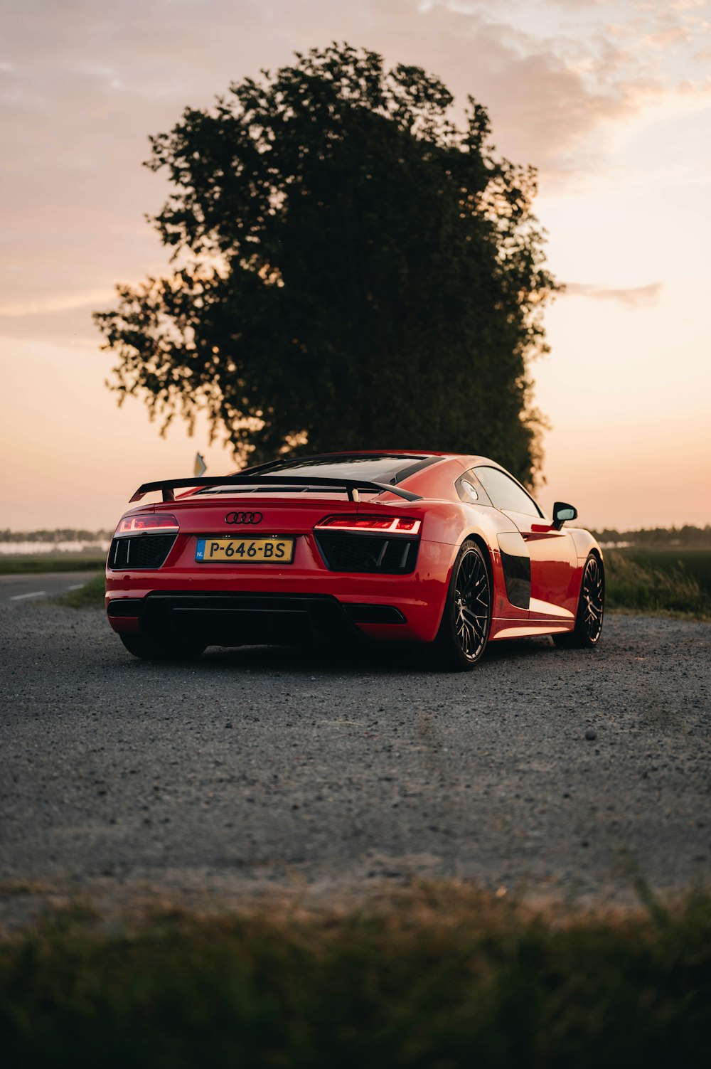 a red sports car parked on the side of a road