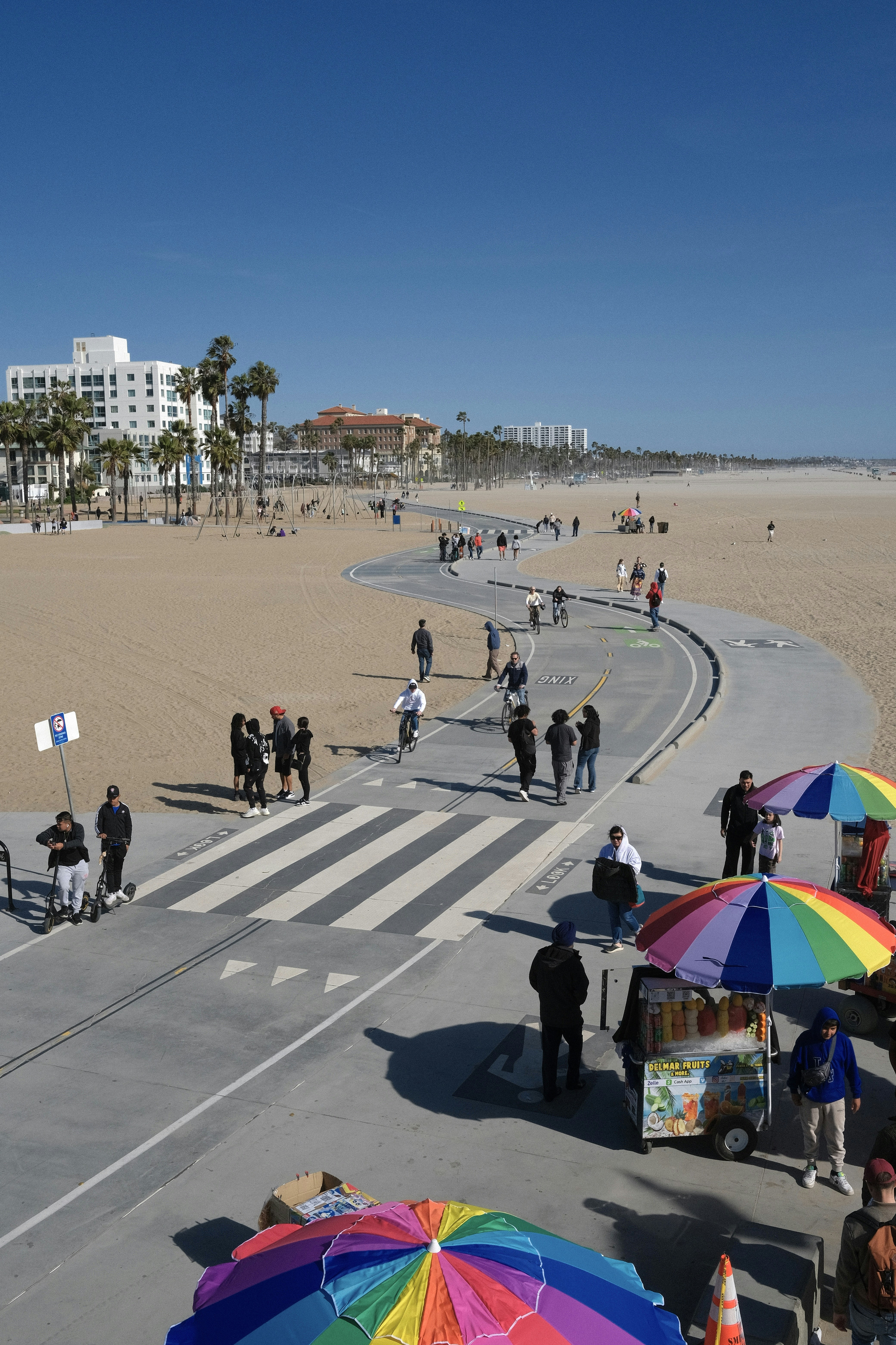 a group of people standing on top of a sandy beach
