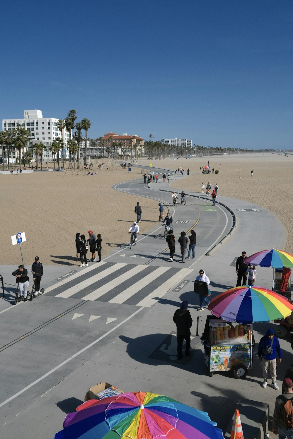 a group of people standing on top of a sandy beach