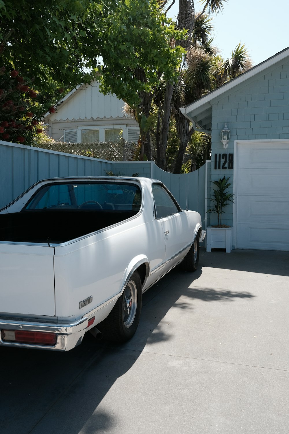 a white car parked in front of a house