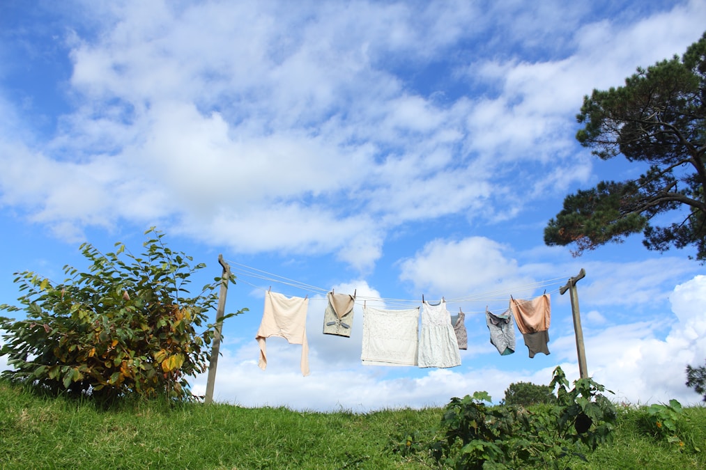 Laundry pinned to a clothesline drying outdoors under a bright blue sky