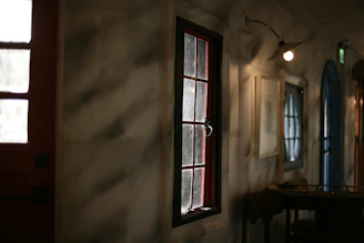 Warm, inviting shot of a cozy Scandinavian-style restaurant corner with soft lighting and deep crimson accents.