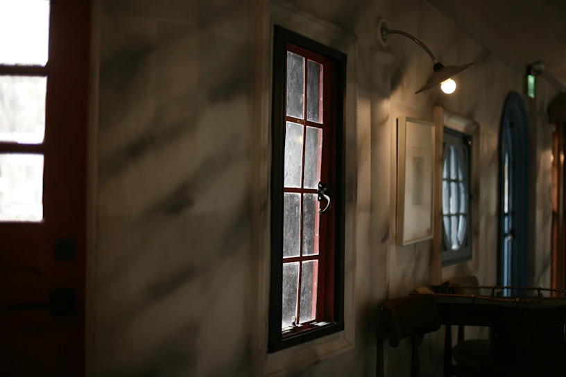Warm Scandinavian-style photo of a rustic artisanal restaurant interior with deep crimson accents and natural wood textures.