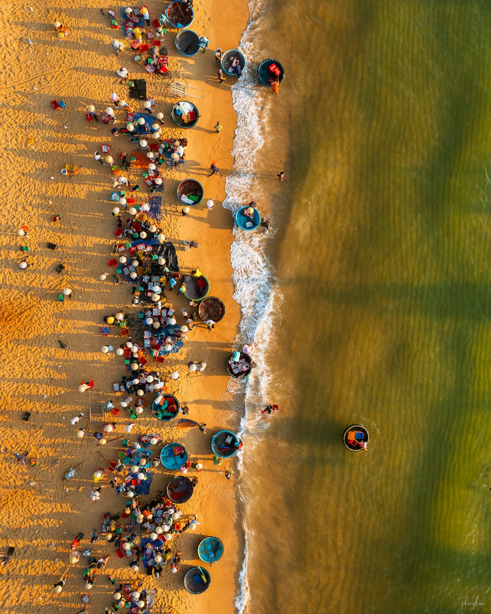 a group of people standing on top of a sandy beach