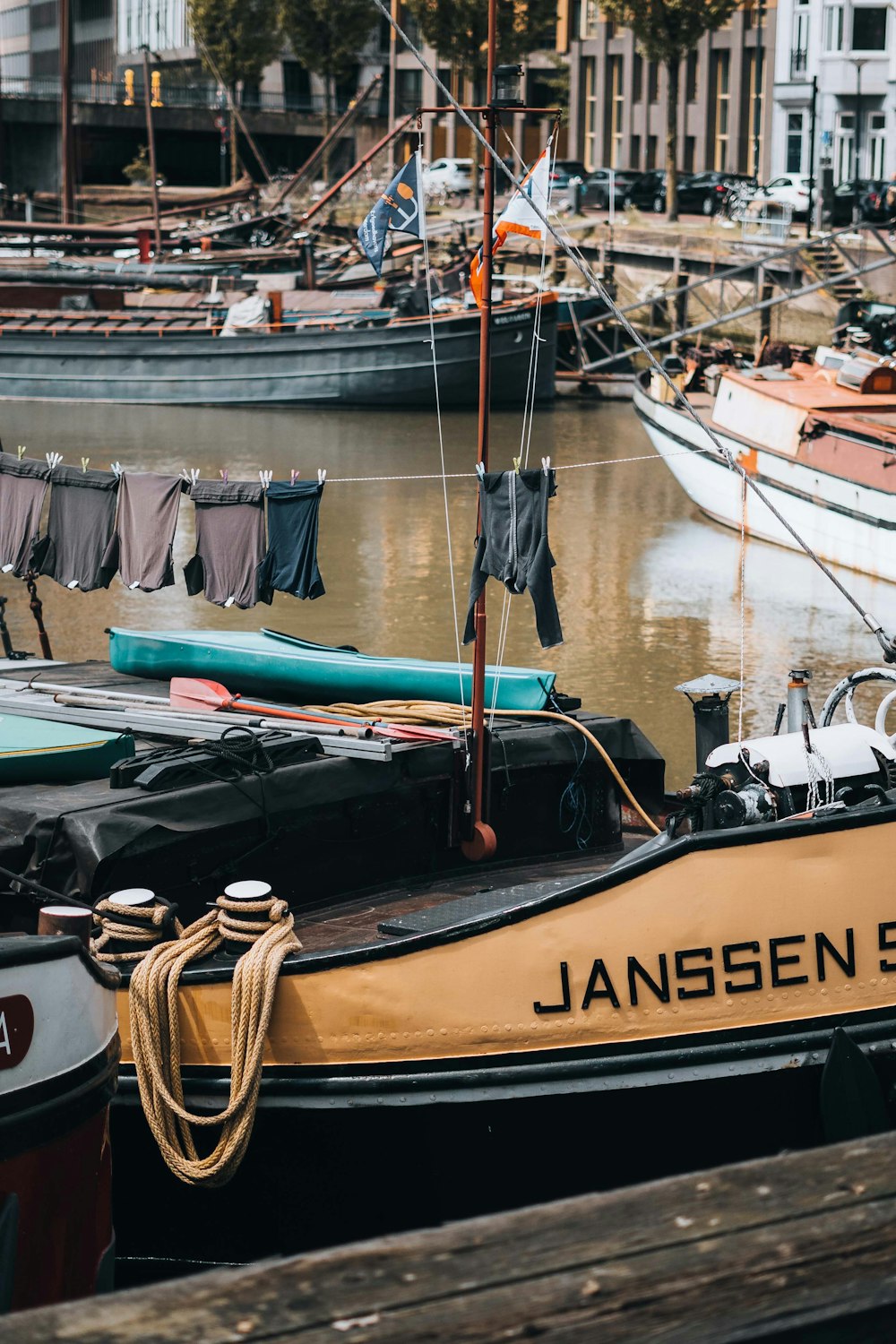 a yellow and black boat docked in a harbor