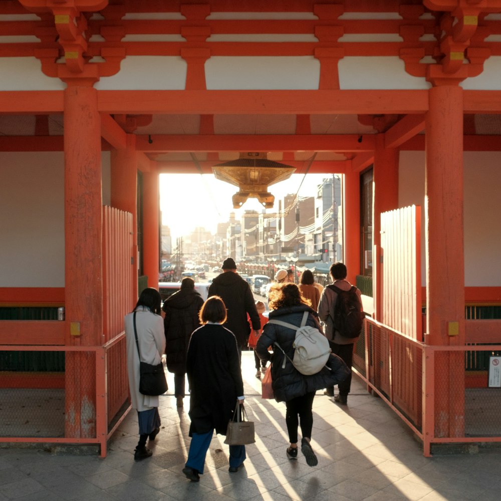 a group of people walking down a walkway