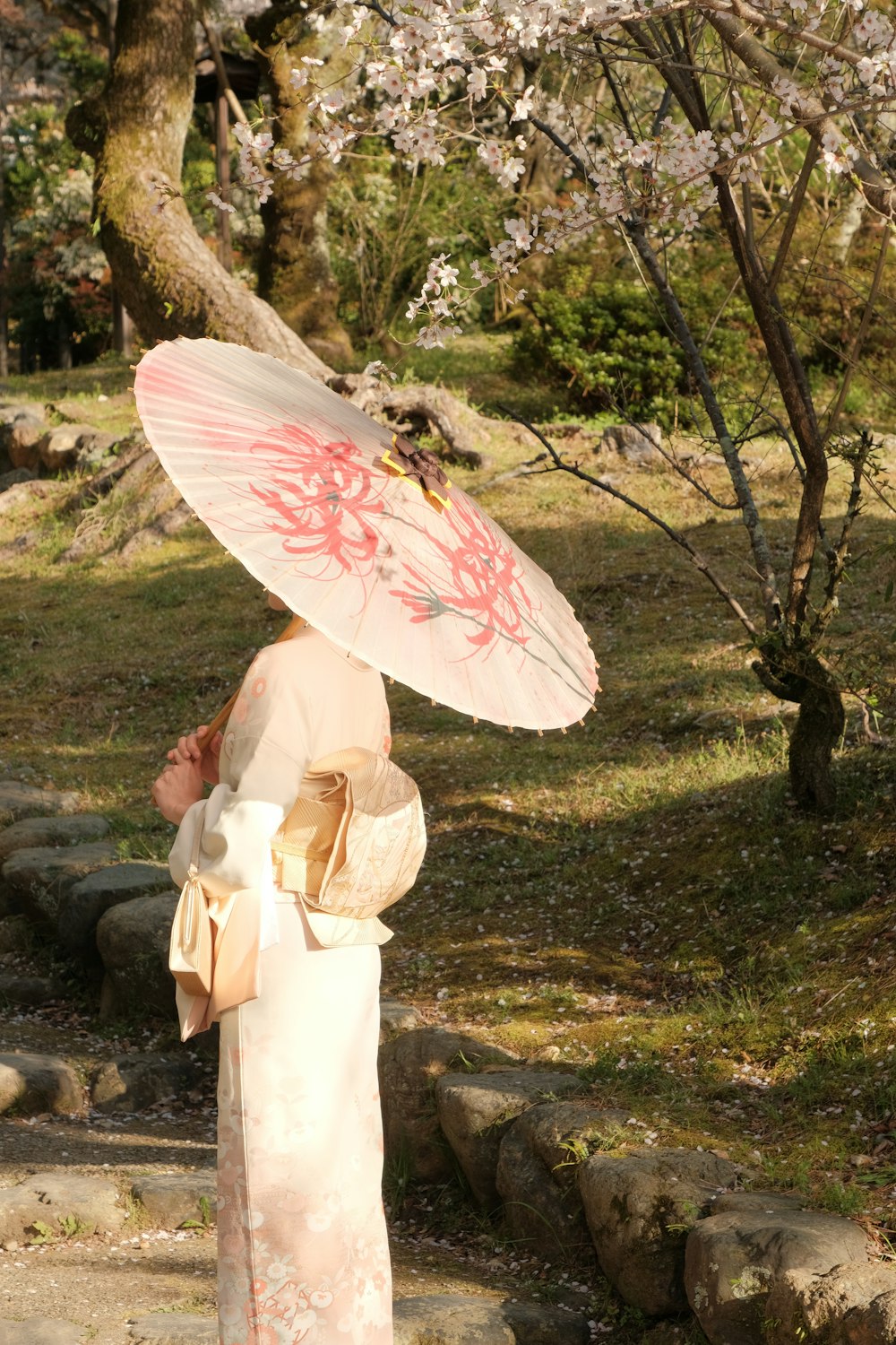 a woman in a kimono with a parasol