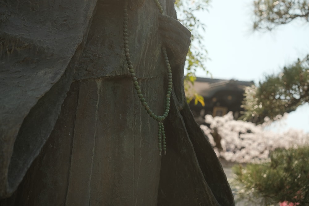 a close up of a statue with a rosary on it