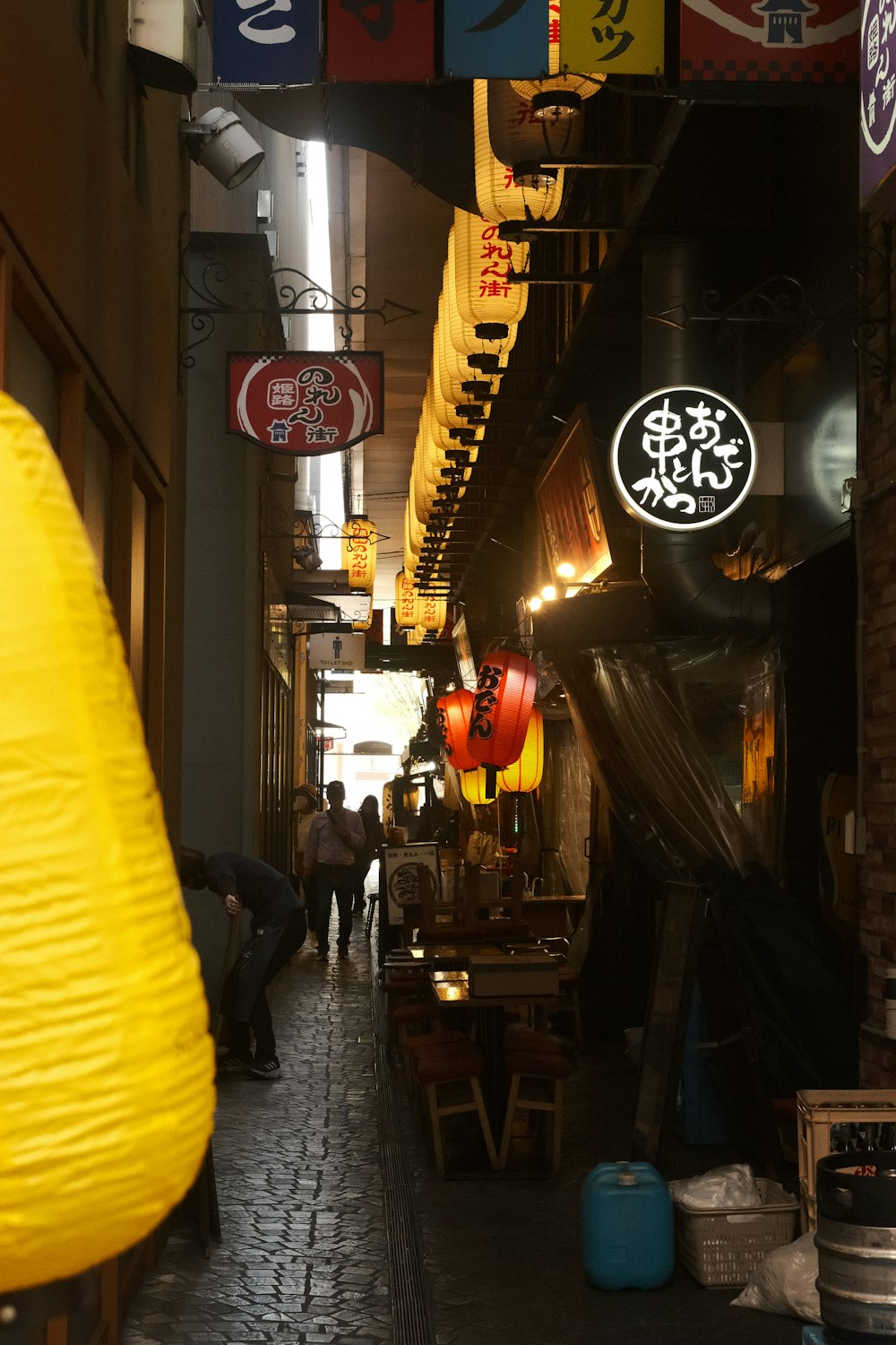 a narrow alley way with people walking down it