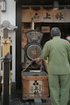 a man standing next to a wooden box filled with food