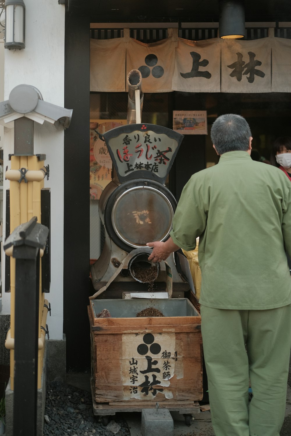 a man standing next to a wooden box filled with food