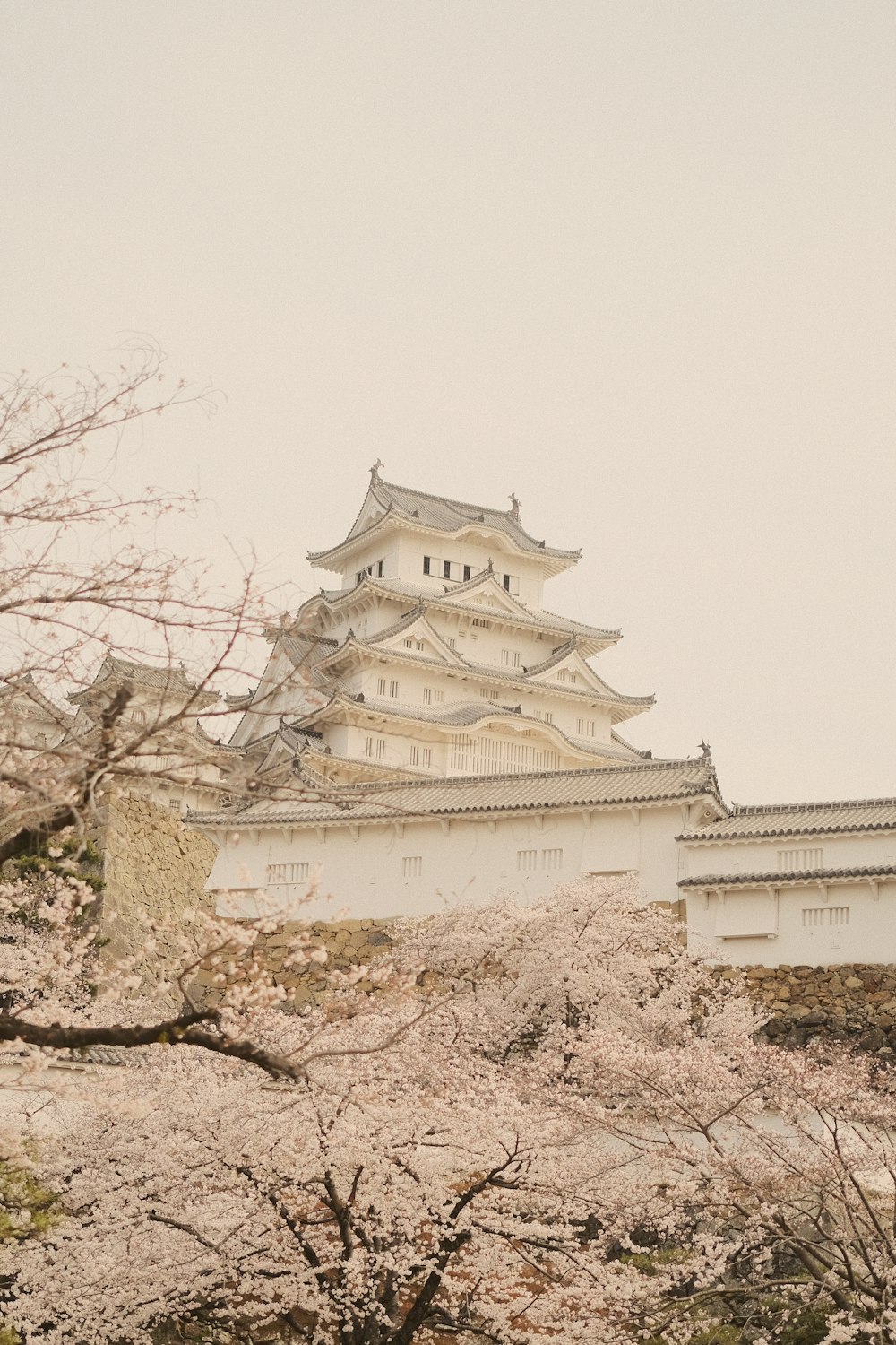 a tall white building sitting on top of a hill