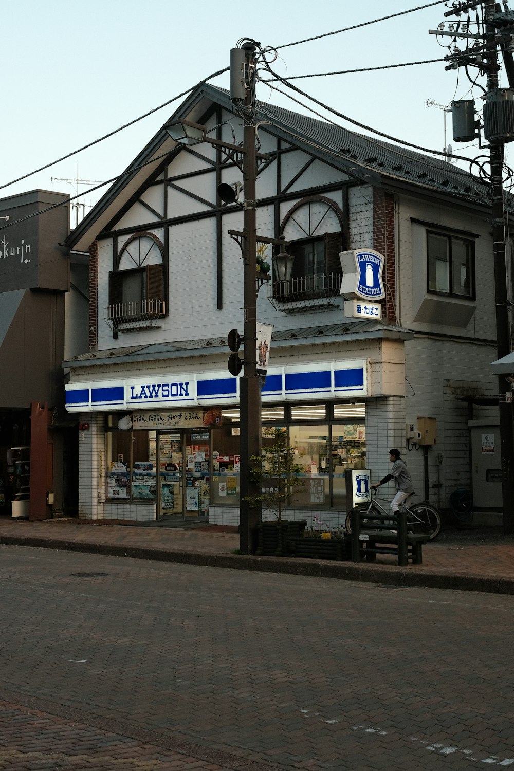 a street corner with a building and a motorcycle parked in front of it