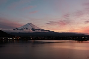 A picturesque landscape of Mount Fuji at sunset.