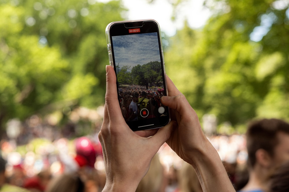 a person taking a picture with a cell phone